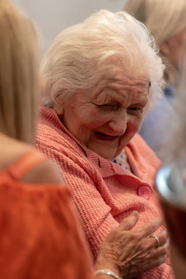 A resident laughing with a friend at Aria Care Home