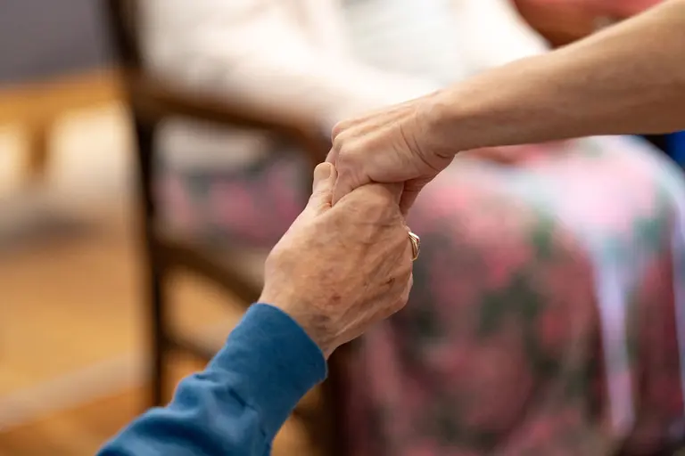 Hands held together at Aria Care Home