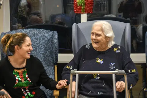Residents, families and the team celebrating Christmas 2018.