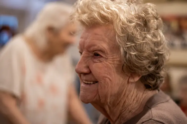 Two residents dancing together, hands raised